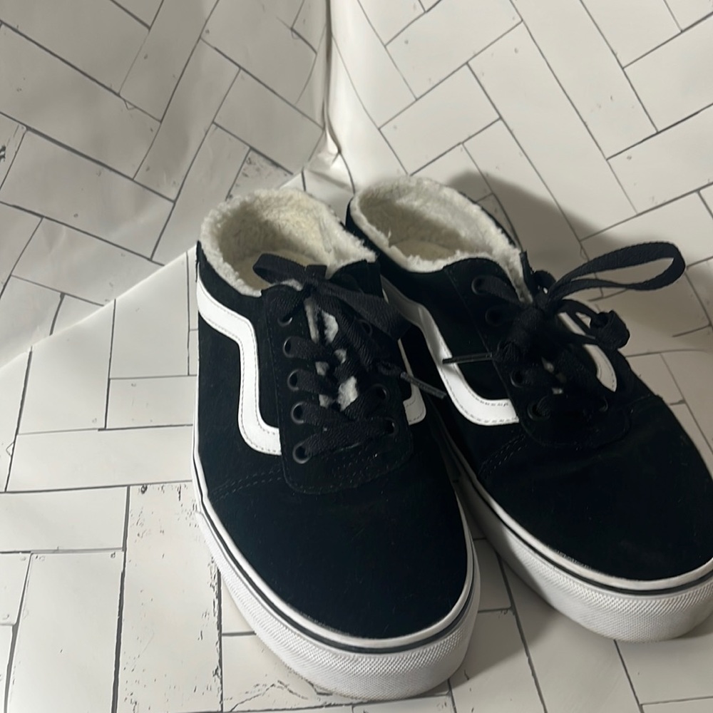 Vans black leather slides.